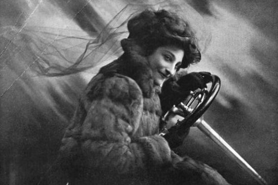 Miss Dorothy Levitt, first British race car driver, comfortably behind the wheel in the early 1900's.